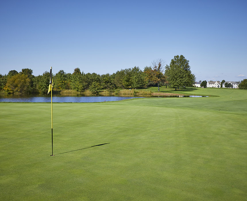 Yellow flag on golf course fairway